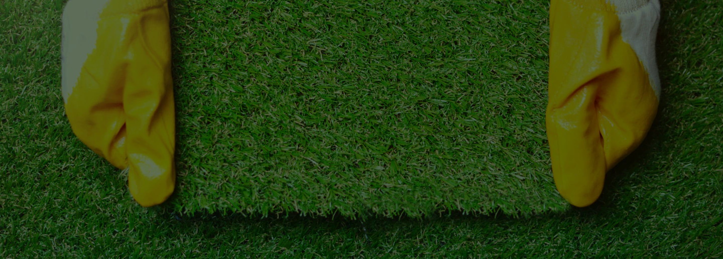 man showing quality synthetic grass